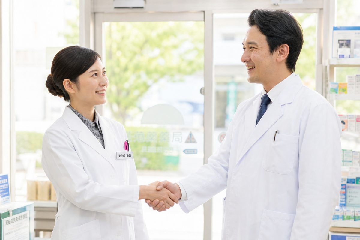 握手を交わす薬剤師と薬局経営者